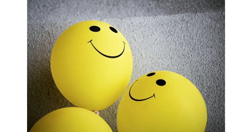 3 yellow balloons with smileys