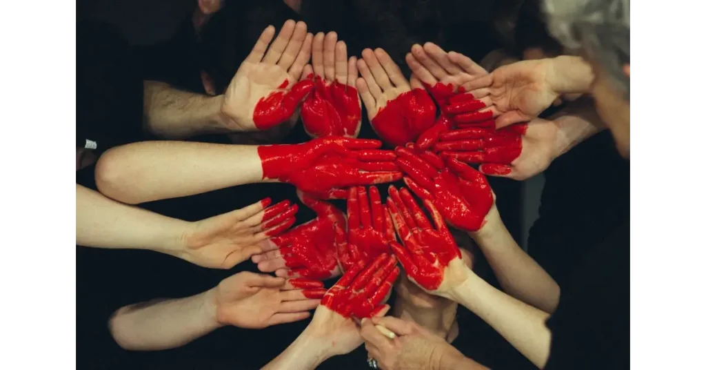 Hands painted with red color forming a hearth