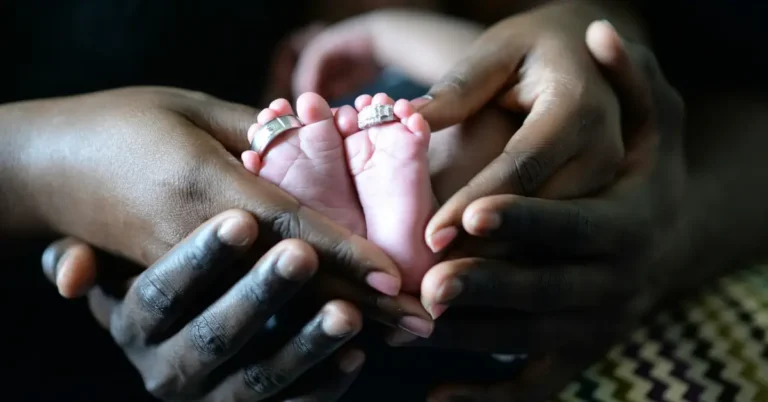 Holding baby feets