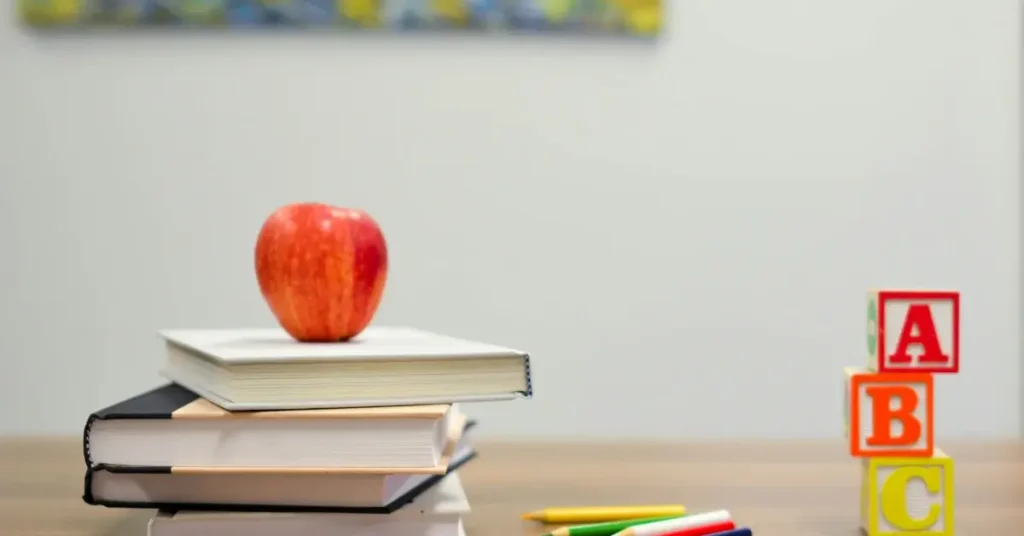 Desk with apple on books