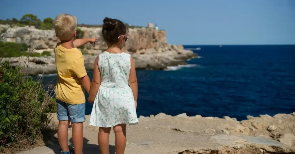 Kids standing on a cliff