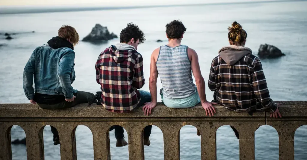 Group of Teenagers sitting on a bridge