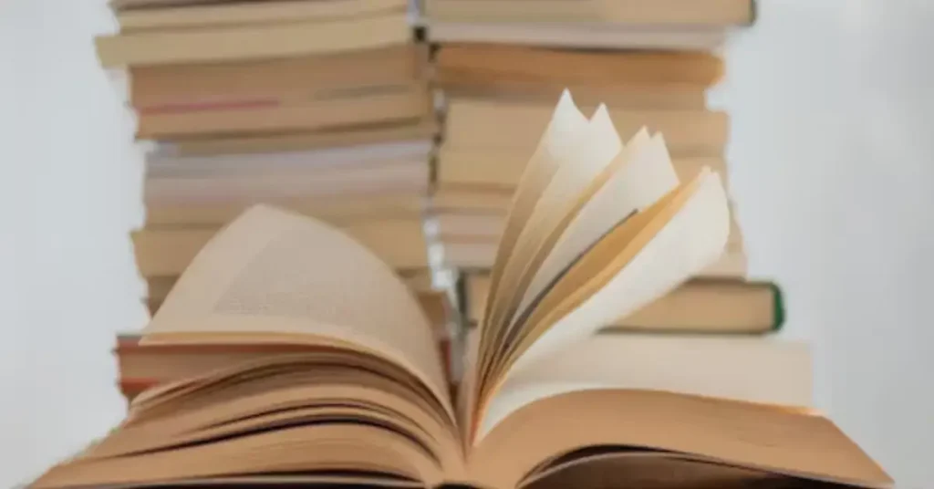 A stack of books with "Words of Affirmation" on the cover, surrounded by uplifting quotes and positive affirmations